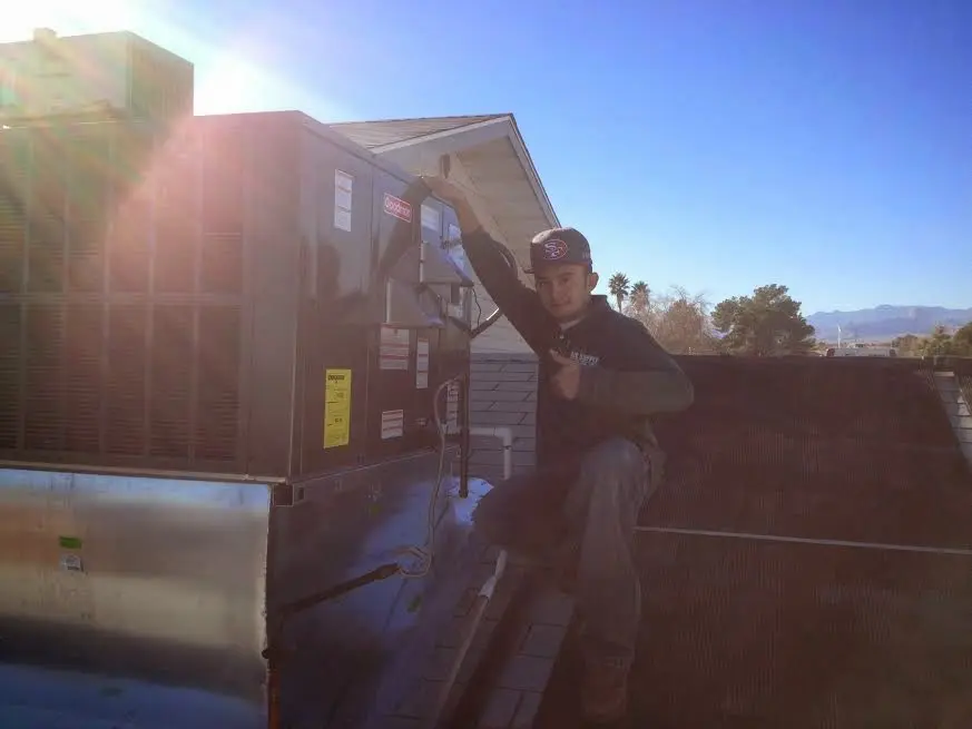 HVAC technician performing AC Tune-Up on a rooftop unit in Waipio Acres